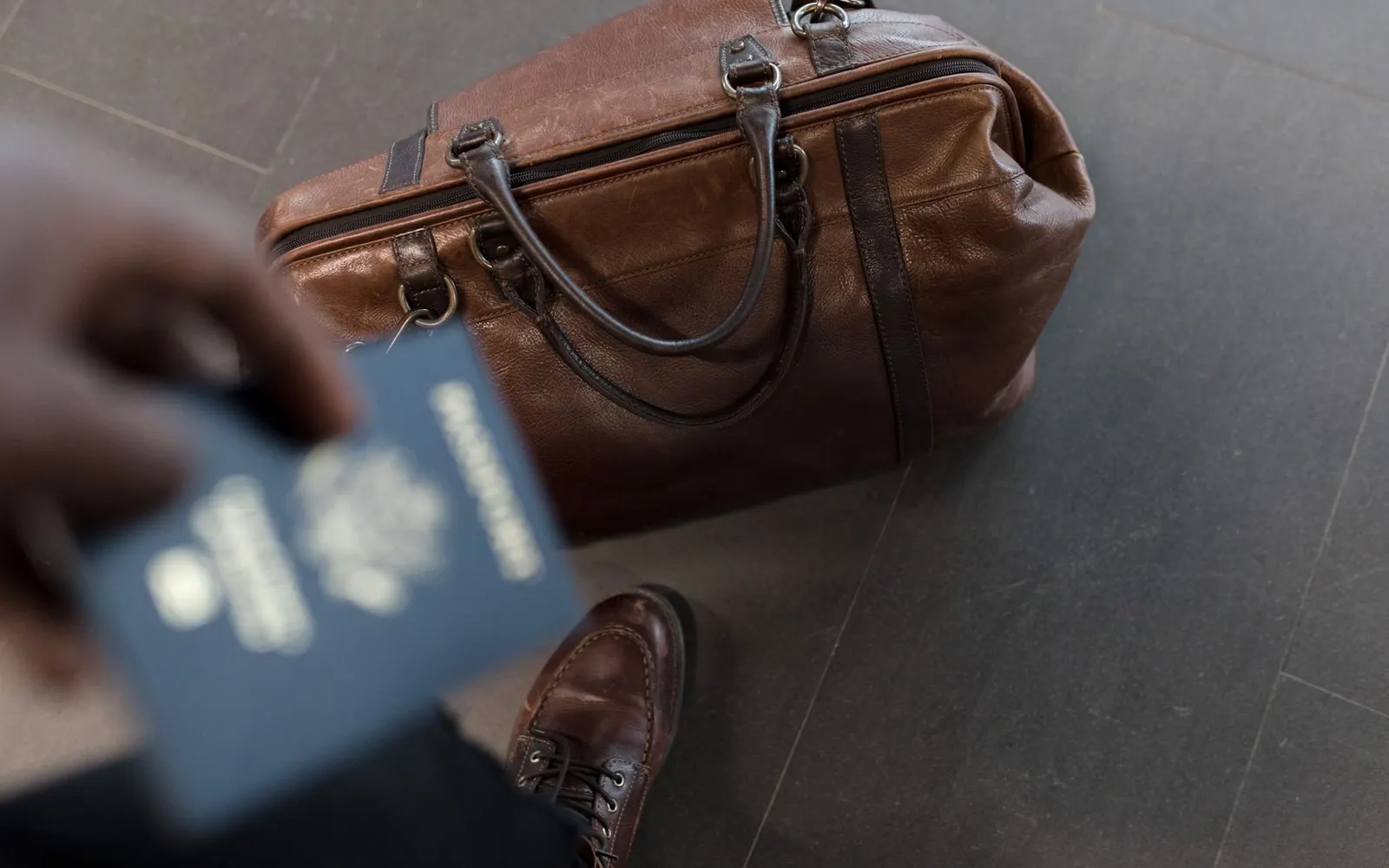 Passeport, carte d'embarquement et carnet posés sur une valise